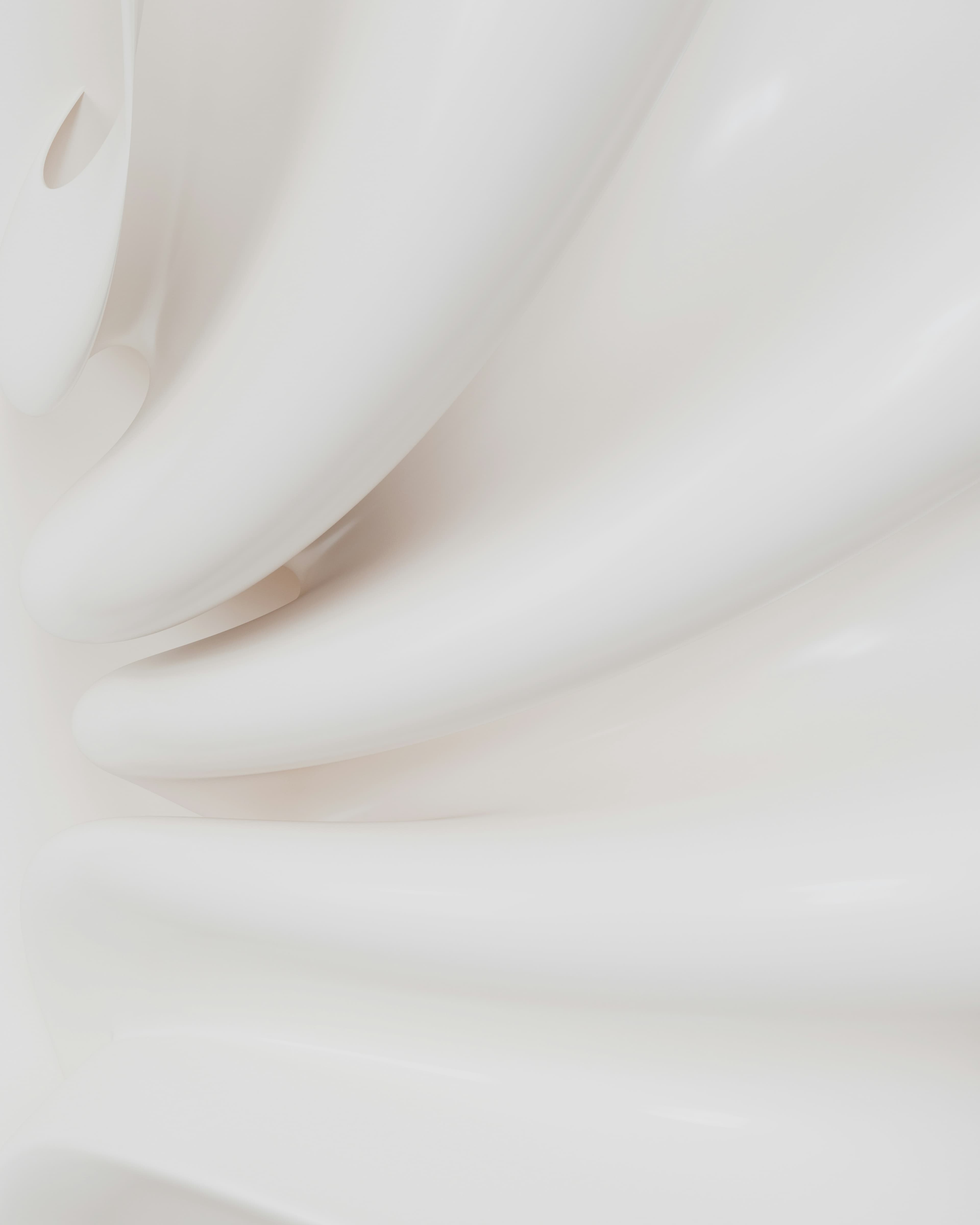 Glossy white cosmetic texture with flowing curves